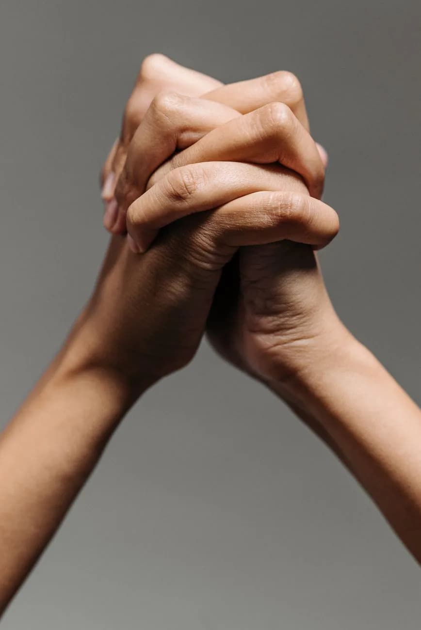 Hands joined together representing human-centered design
